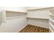 Spacious walk-in closet with built-in shelving and wooden rods for ample storage at 2428 E Iris Dr, Chandler, AZ 85286