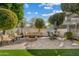 Beautiful backyard features pavers, a fire pit, outdoor seating, and mature landscaping at 2626 E Valencia St, Gilbert, AZ 85296