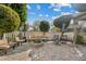 Lush backyard with seating areas, fire pit, manicured lawn, and privacy fencing at 2626 E Valencia St, Gilbert, AZ 85296