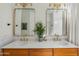 Bathroom featuring a double sink vanity with gold fixtures, white countertops, and a tile backsplash at 2626 E Valencia St, Gilbert, AZ 85296