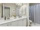 Bright bathroom featuring double sinks, white cabinetry, and neutral walls at 2626 E Valencia St, Gilbert, AZ 85296