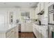 Bright kitchen featuring white cabinets, quartz countertops, modern appliances, and ample natural light at 2626 E Valencia St, Gilbert, AZ 85296