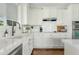 Well-lit kitchen with white cabinets, quartz countertops, subway tile backsplash, and stainless steel appliances at 2626 E Valencia St, Gilbert, AZ 85296