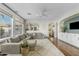 Bright living room with a plush sectional sofa, a ceiling fan, and large windows with designer curtains at 2626 E Valencia St, Gilbert, AZ 85296