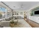 Bright living room with a plush sectional sofa, a ceiling fan, and large windows with designer curtains at 2626 E Valencia St, Gilbert, AZ 85296