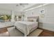 Bright main bedroom with white walls, large windows, modern lighting, and neutral-toned furnishings at 2626 E Valencia St, Gilbert, AZ 85296