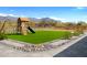 The backyard offers a playset on synthetic grass and a desert view in Arizona at 2775 S Baker Dr, Apache Junction, AZ 85119