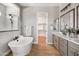 A bright bathroom featuring a soaking tub, walk-in shower, double sink vanity, and walk-in closet at 2775 S Baker Dr, Apache Junction, AZ 85119