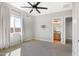 Bright, airy bedroom featuring a ceiling fan, neutral carpet, and an ensuite bathroom at 2775 S Baker Dr, Apache Junction, AZ 85119