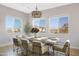 Elegant dining room with scenic views features a modern chandelier, a large table, and bright natural light at 2775 S Baker Dr, Apache Junction, AZ 85119