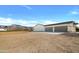 The exterior of this Arizona home features a three car garage and beautiful views of the nearby mountains at 2775 S Baker Dr, Apache Junction, AZ 85119