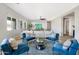 Bright living room featuring stylish blue chairs, a ceiling fan, and an open layout at 2775 S Baker Dr, Apache Junction, AZ 85119