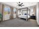 The main bedroom features large windows, a ceiling fan, and a decorative canopy bed at 2775 S Baker Dr, Apache Junction, AZ 85119