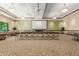 A spacious meeting room with comfortable seating, a large screen, and ample natural light at 2798 W William Ln, San Tan Valley, AZ 85144