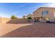 Exterior rear view of home featuring a covered patio and spacious backyard with a low-maintenance landscape at 28549 N Dolomite Ln, San Tan Valley, AZ 85143