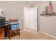 Bedroom with simple decor, beige carpet, and convenient access to another room through a white door at 28549 N Dolomite Ln, San Tan Valley, AZ 85143