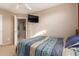 Bedroom with soft lighting, neutral walls, and a wall-mounted television for relaxed viewing at 28549 N Dolomite Ln, San Tan Valley, AZ 85143