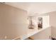 Hallway with neutral tones, leading to the bedroom with desk and decor at 28549 N Dolomite Ln, San Tan Valley, AZ 85143