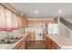 A spacious kitchen features wooden cabinets, a kitchen island, and modern appliances at 28549 N Dolomite Ln, San Tan Valley, AZ 85143