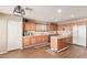 A spacious kitchen features wooden cabinets, a kitchen island, and modern appliances at 28549 N Dolomite Ln, San Tan Valley, AZ 85143