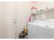 Bright laundry room with a white washer and dryer, storage shelf and adjacent closet for easy access at 28549 N Dolomite Ln, San Tan Valley, AZ 85143