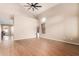 Bright living room featuring hardwood floors, high ceilings, large window with blinds, and neutral paint at 28549 N Dolomite Ln, San Tan Valley, AZ 85143