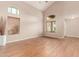 Bright living room featuring hardwood floors, large windows with blinds, and neutral paint at 28549 N Dolomite Ln, San Tan Valley, AZ 85143