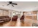 Open-concept living room featuring hardwood floors, comfortable seating, and access to the kitchen at 28549 N Dolomite Ln, San Tan Valley, AZ 85143