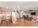 Open-concept living room featuring hardwood floors, kitchen with island, stairs and comfortable seating at 28549 N Dolomite Ln, San Tan Valley, AZ 85143