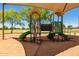 Playground with shade cover, climbing structures, and slides on a sunny day at 28549 N Dolomite Ln, San Tan Valley, AZ 85143