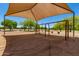 Swings at playground with shade cover and trees on a sunny day at 28549 N Dolomite Ln, San Tan Valley, AZ 85143