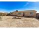 Backyard with a picnic table, desert landscape and wood fence at 2900 E Paloma Rd, Eloy, AZ 85131