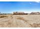 Expansive backyard with dirt and desert vegetation, complete with a fence and blue sky overhead at 2900 E Paloma Rd, Eloy, AZ 85131