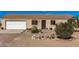 Home featuring an attached garage, desert landscaping, and a charming front entrance at 2900 E Paloma Rd, Eloy, AZ 85131