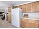 Kitchen area showcasing ample cabinet space and a white refrigerator at 2900 E Paloma Rd, Eloy, AZ 85131