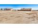 Large vacant land lot with houses in the background at 2900 E Paloma Rd, Eloy, AZ 85131