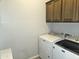 Bright laundry room with a new Maytag washer and dryer and upper cabinets at 3117 S Signal Butte Rd # 480, Mesa, AZ 85212