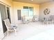 Covered patio features lounge seating and neutral walls with decor at 3117 S Signal Butte Rd # 480, Mesa, AZ 85212