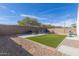 Backyard showcasing a synthetic lawn, gravel landscaping and outdoor seating at 3206 N 310Th Ln, Buckeye, AZ 85396