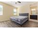 Bedroom with wood-look floors, natural light, and ensuite bathroom at 3206 N 310Th Ln, Buckeye, AZ 85396