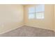 Bedroom with carpet, yellow walls, and a window at 3206 N 310Th Ln, Buckeye, AZ 85396