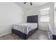 Bedroom with a bed, ceiling fan, window and wood-look floor at 3206 N 310Th Ln, Buckeye, AZ 85396