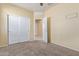 Bedroom with neutral walls and flooring, closet and doorway at 3206 N 310Th Ln, Buckeye, AZ 85396