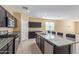 Kitchen featuring an island with granite countertops, stainless steel appliances and dark wood cabinets at 3206 N 310Th Ln, Buckeye, AZ 85396