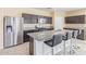 Modern kitchen featuring stainless steel appliances, granite countertops, and an island with bar seating at 3206 N 310Th Ln, Buckeye, AZ 85396