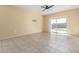 A spacious room with neutral tones, tile floors and sliding glass doors at 3206 N 310Th Ln, Buckeye, AZ 85396