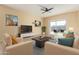 Cozy living room with neutral tones, comfortable seating, and sliding door access to patio at 3206 N 310Th Ln, Buckeye, AZ 85396