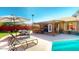 Beautiful outdoor space with a pool, covered patio, lounge chairs, and dining area for ultimate relaxation at 3215 N Margate Pl, Chandler, AZ 85224