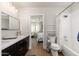 Bright bathroom featuring dual vanity, tub and shower at 345 W Wilshire Dr, Phoenix, AZ 85003