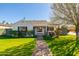 Charming single-story home with white exterior, manicured lawn, and inviting walkway at 345 W Wilshire Dr, Phoenix, AZ 85003